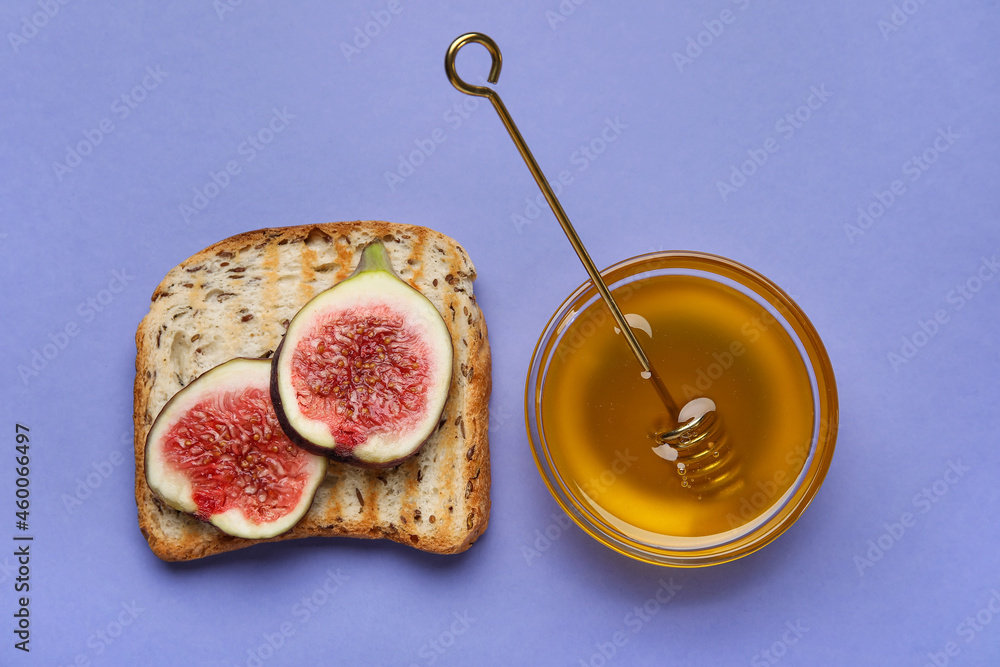 Toast with ripe figs and honey on color background