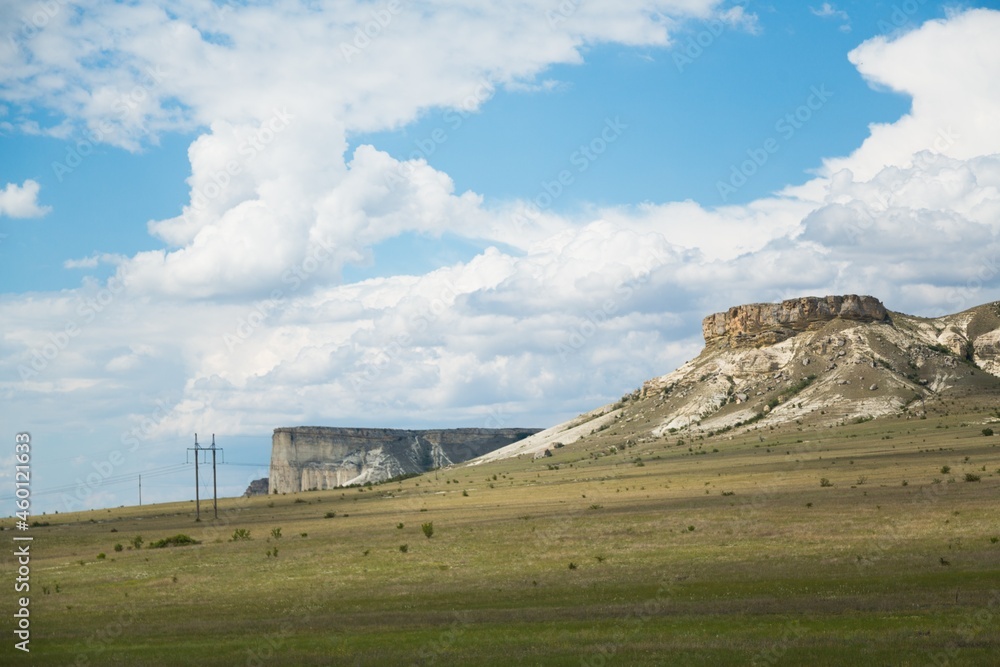 Beautiful hilly landscape with a mountain in the foreground with blue sky