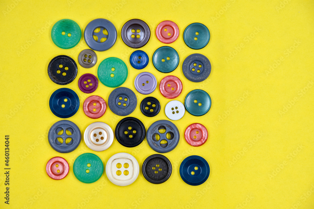 A variety of buttons on a yellow background