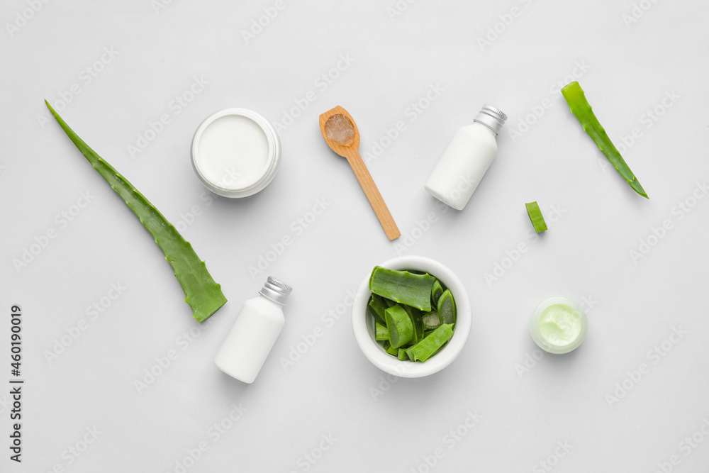 Different cosmetic products with aloe on light background