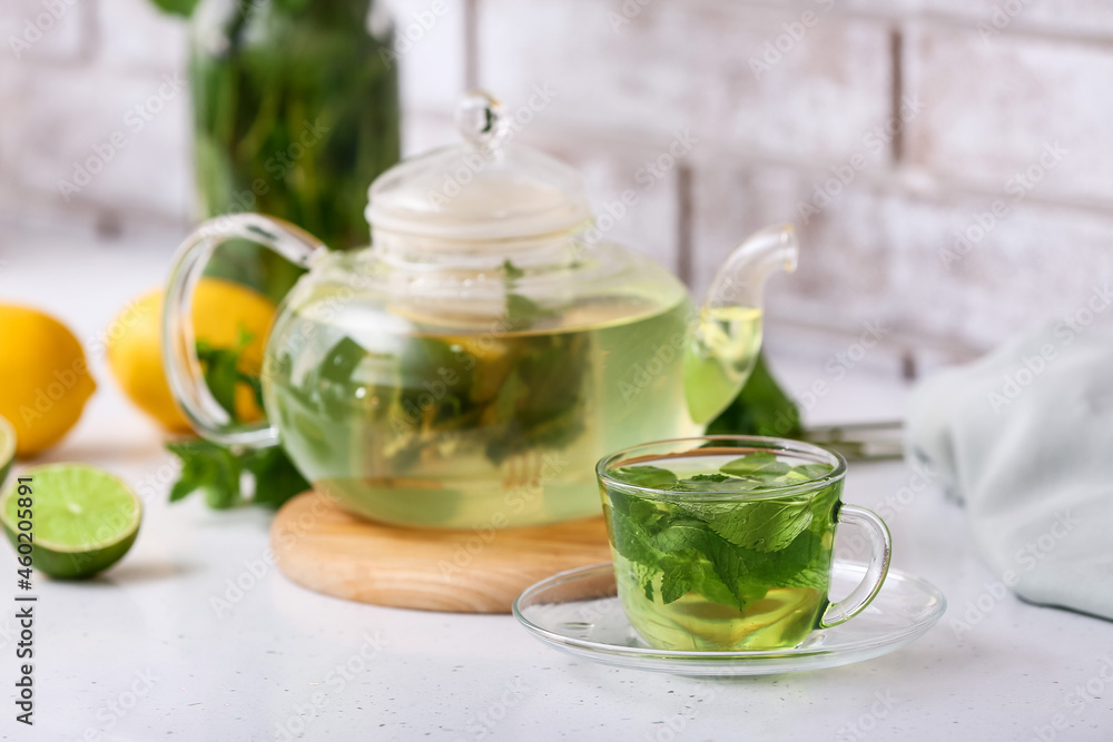 Glass cup of tasty mint tea on table, closeup