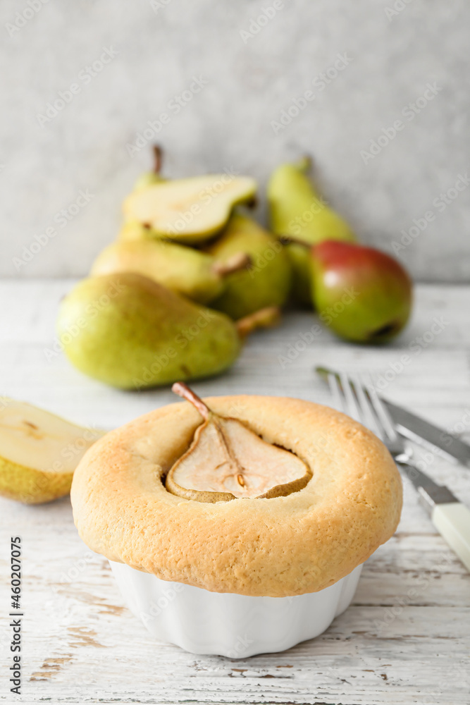 Tasty pear pot pie on light wooden background