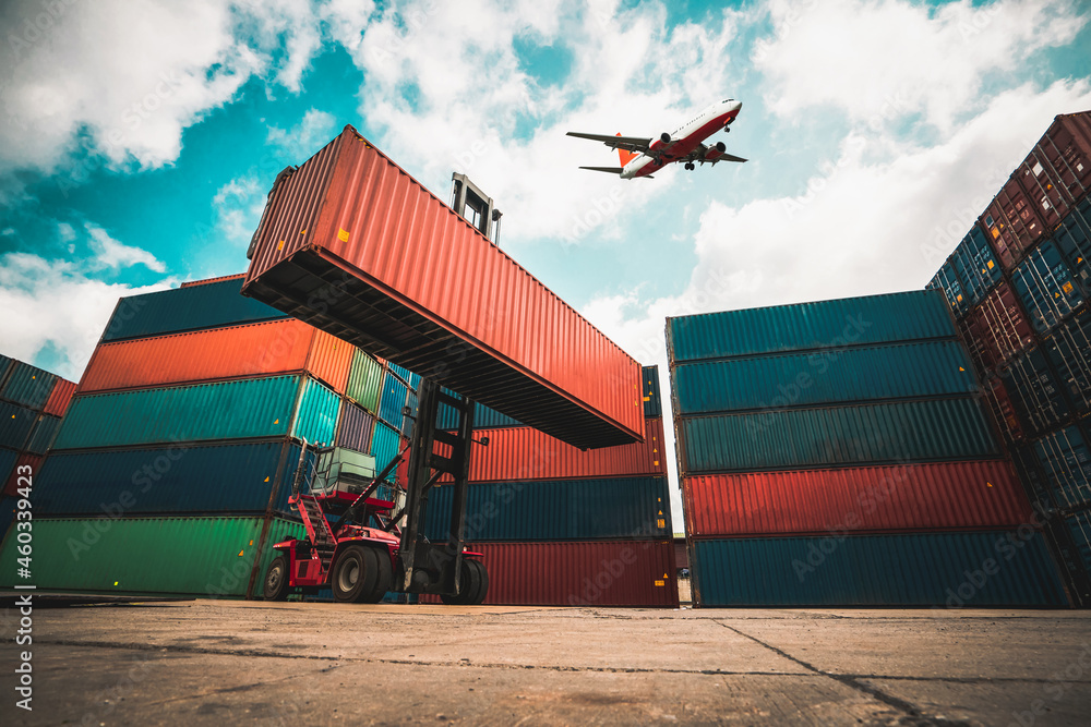 Cargo container for overseas shipping in shipyard with airplane in the sky . Logistics supply chain 