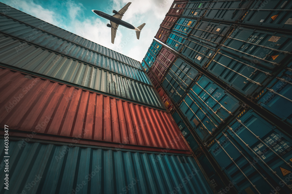 Freight airplane flying above overseas shipping container . Logistics supply chain management and in