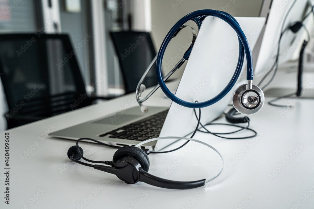 Headset and doctor equipment at clinic ready for actively support for patient by online video call .