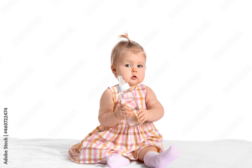 Cute baby girl with bottle of water on white background