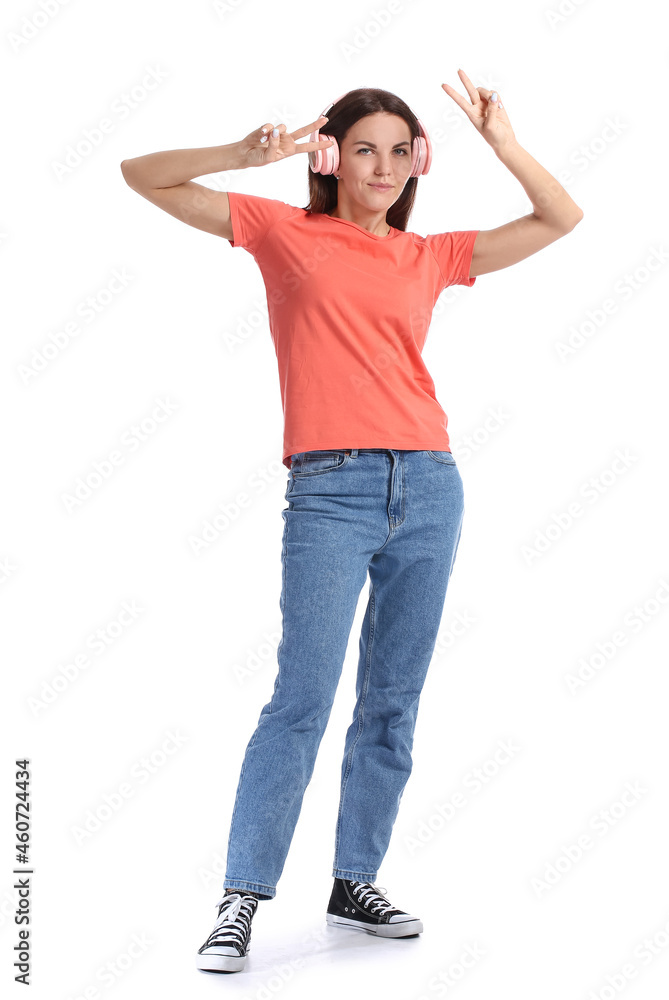 Pretty young woman listening to music on white background