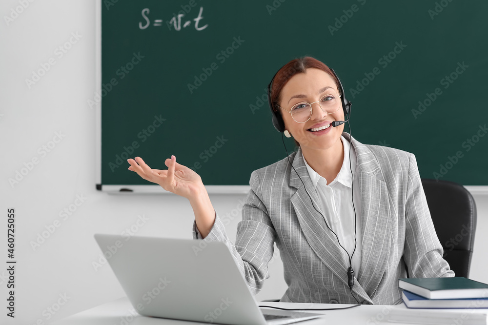 Teacher conducting lesson online in classroom