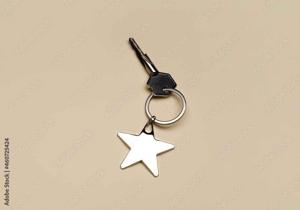 Key with keychain on beige background