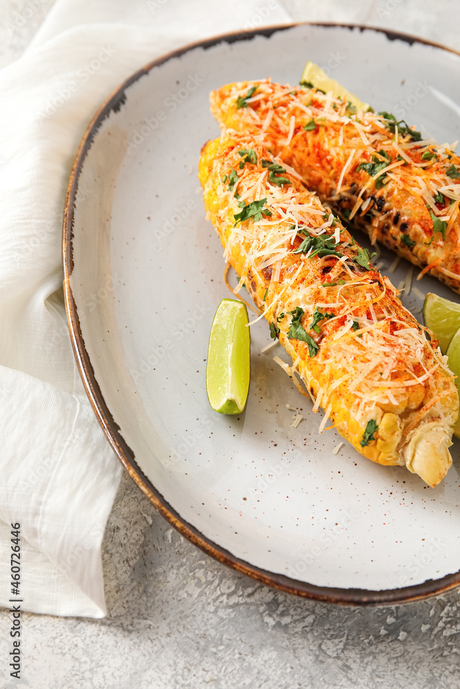 Plate with tasty Elote Mexican Street Corn on grey background, closeup