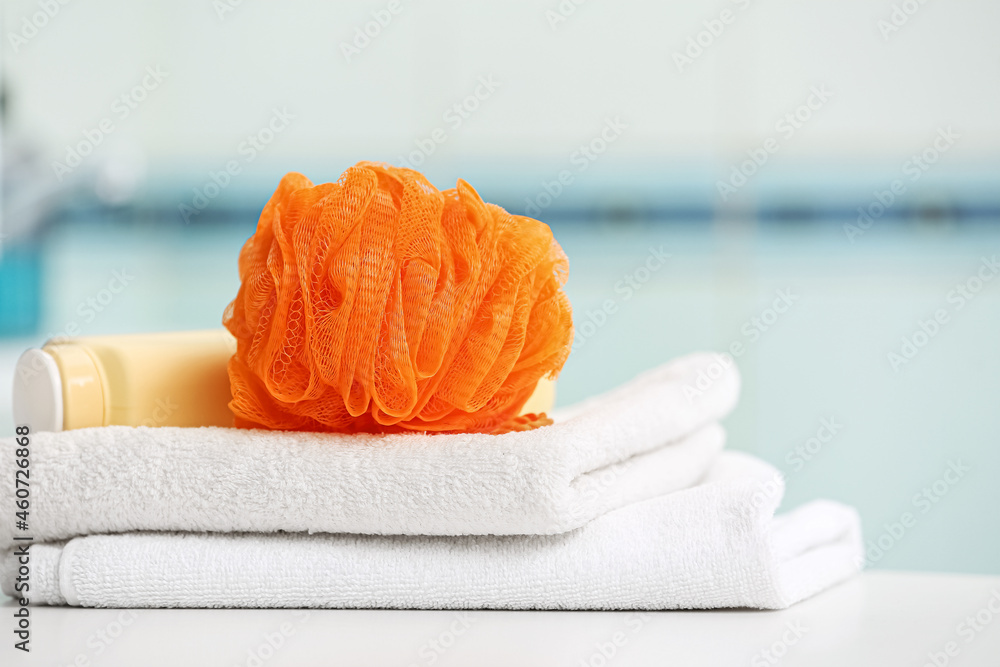 Clean towels and orange sponge on table