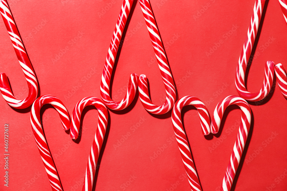 Christmas composition with candy canes on red background