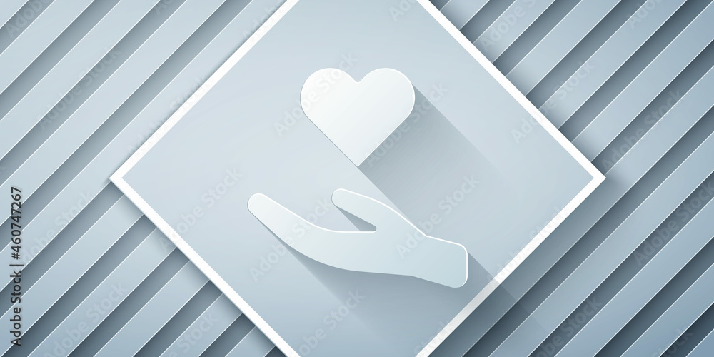 Paper cut Heart in hand icon isolated on grey background. Hand giving love symbol. Valentines day sy