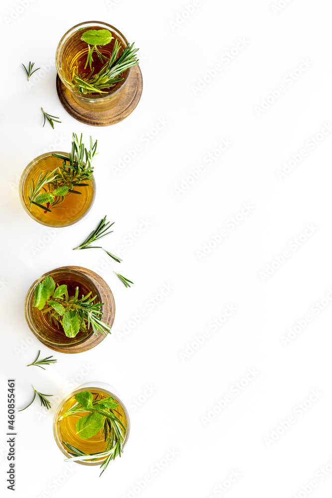 Fefreshing drink of cold tea and rosemary herbs in glasses