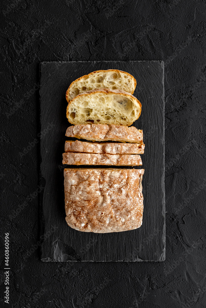 Freashly backed bread slice on cutting board, top view