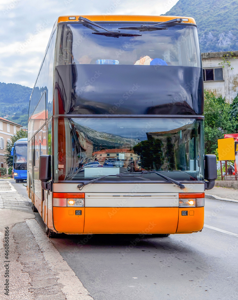 Double decker tourist bus on the street of a European city.