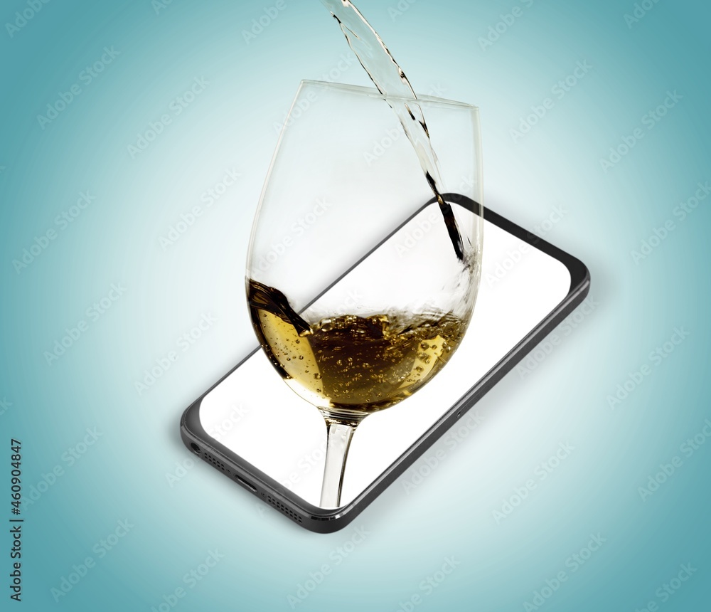 Modern artwork. Glass filling with wine from a bottle in the phone screen