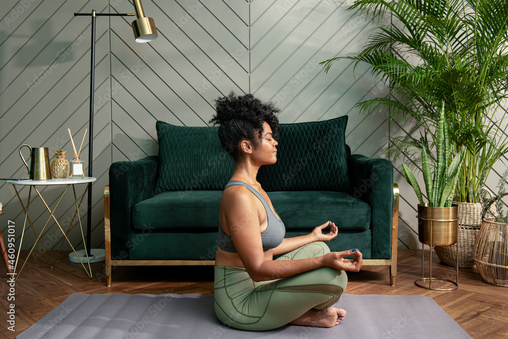 Healthy woman meditating in the living room