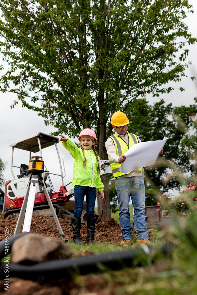 Contractor and his daughter at the construction site