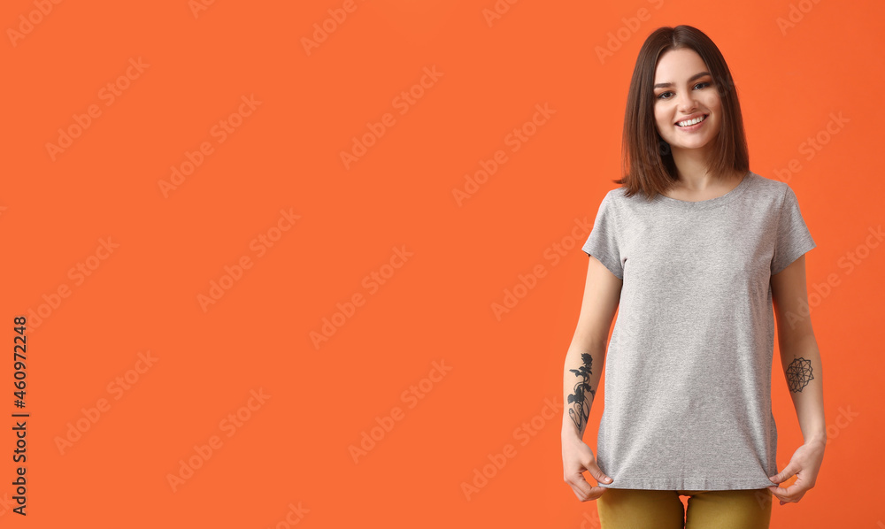 Young woman in modern t-shirt on color background