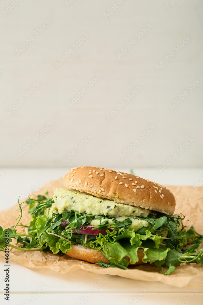 Tasty vegetarian burger on table