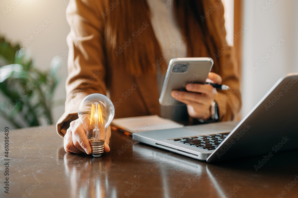 business hand showing creative business strategy with light bulb as concept