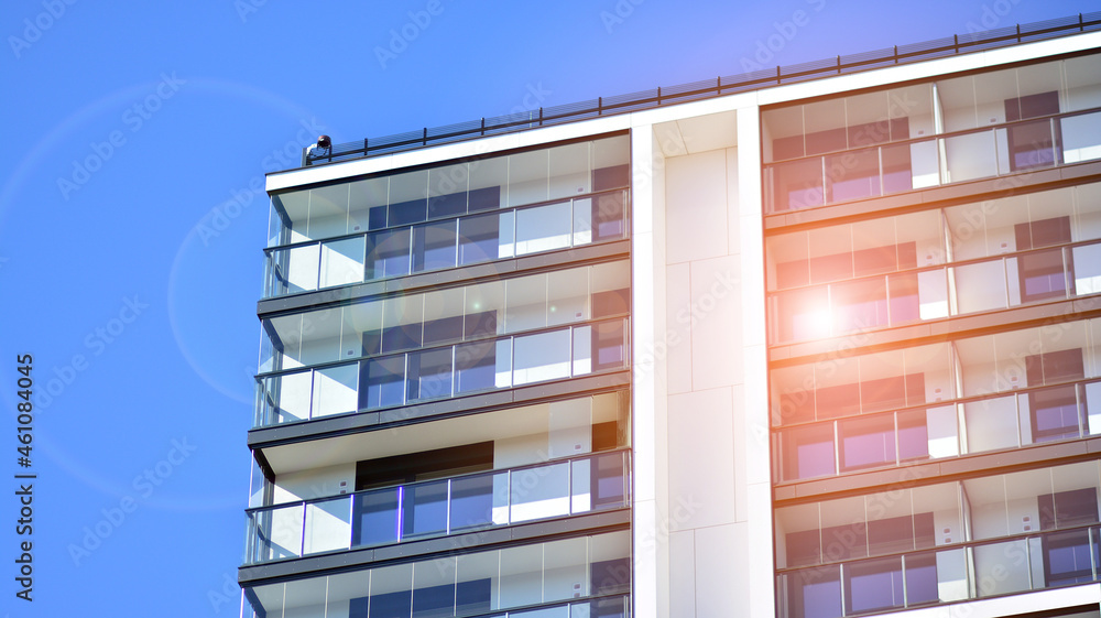 Modern apartment building. Modern urban architecture and details of building facade. Sunlight.