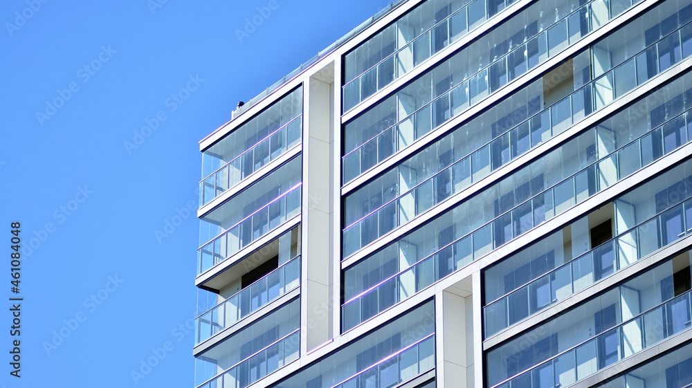 Modern apartment building. Modern urban architecture and details of building facade. Sunlight.