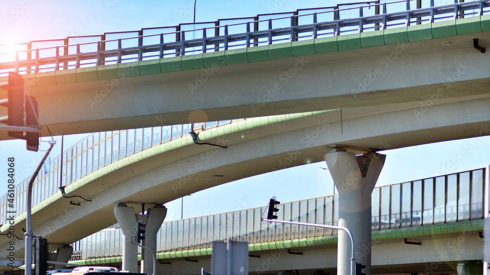 Bridge against the blue sky. Motorway flyover. Elevated roads on sunny day.