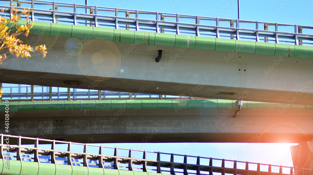 Bridge against the blue sky. Motorway flyover. Elevated roads on sunny day.