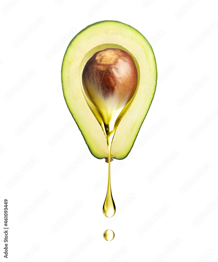 Drop of oily liquid flowing from a half of avocado on a white background