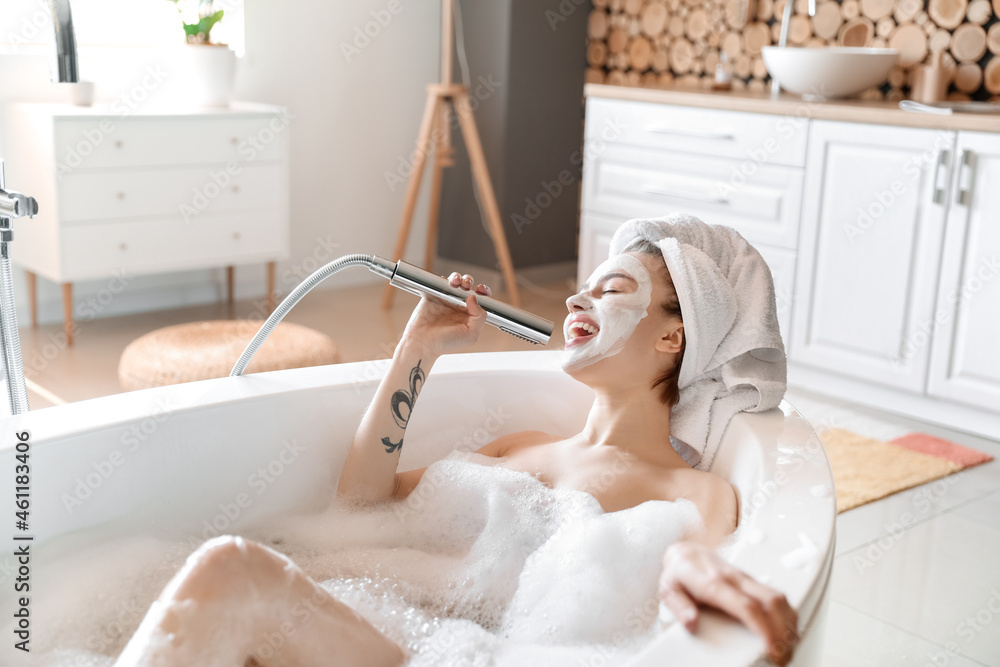 Young woman singing while taking bath at home