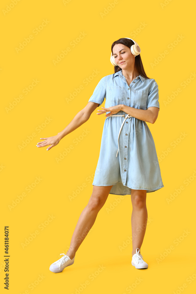 Pretty young woman listening to music on color background