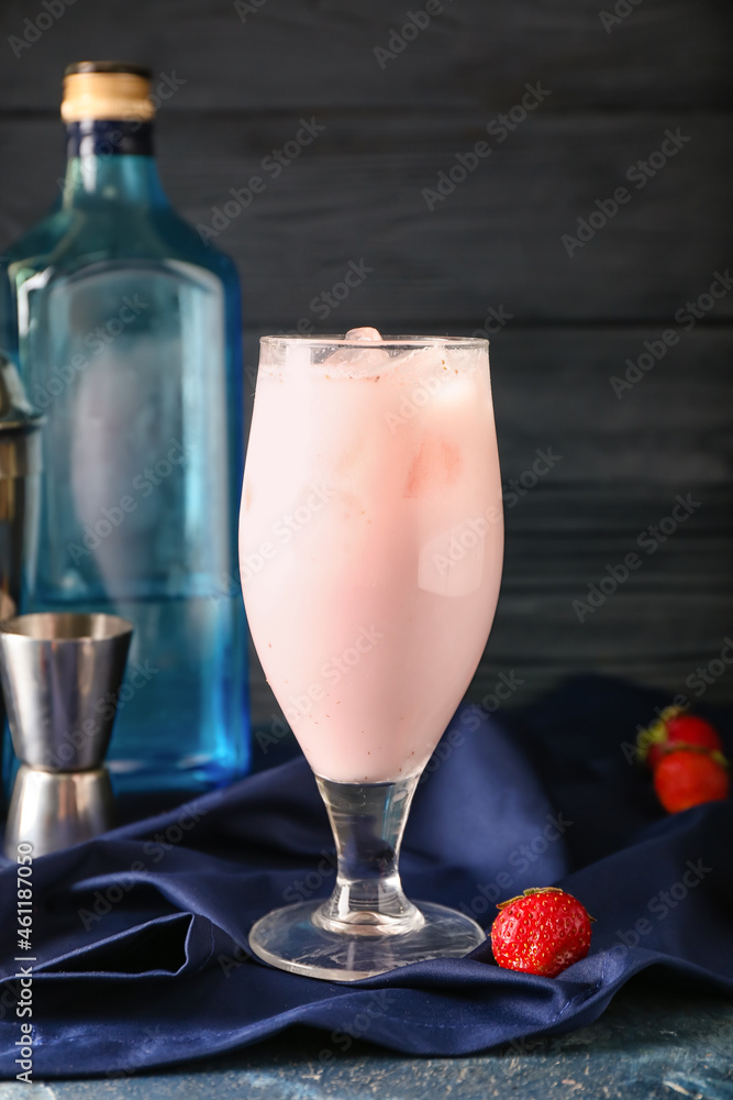 Glass of strawberry Pina Colada cocktail on dark wooden background