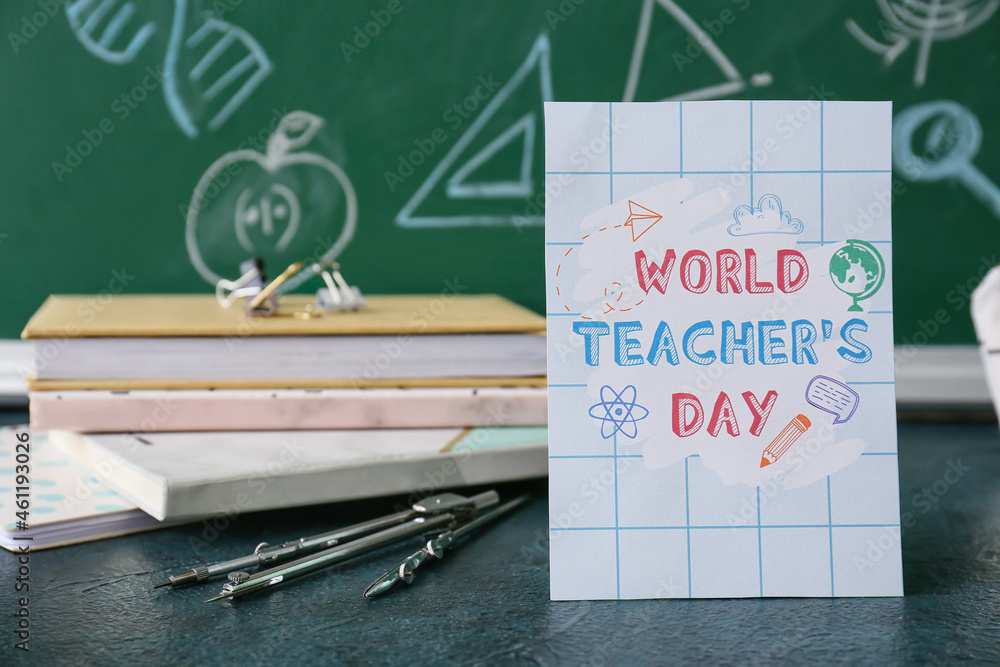 Greeting card for Teachers Day and stationery on table against blackboard