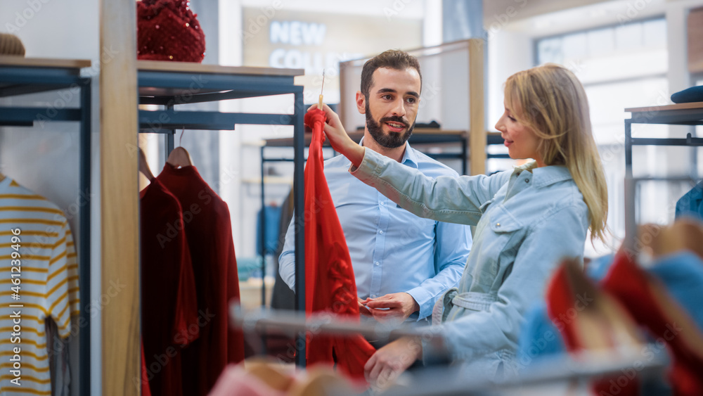 Beautiful Female Customer Shopping in Clothing Store, Retail Sales Associate Helps with Advice. Dive