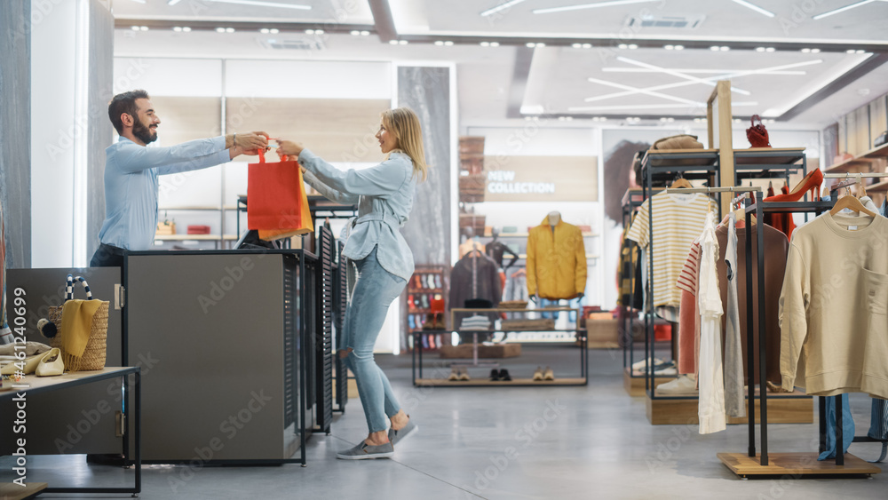 Clothing Store: Young Woman at Counter Takes Shopping Bags with Clothes from Friendly Retail Sales A