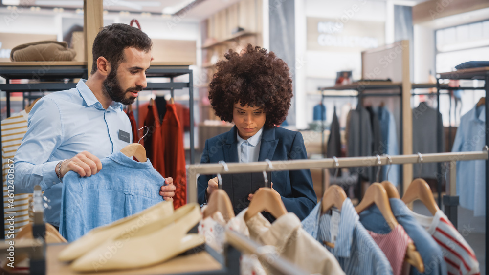 Clothing Store: Businesswoman Uses Tablet Computer, Talks to Visual Merchandising Specialist, Collab