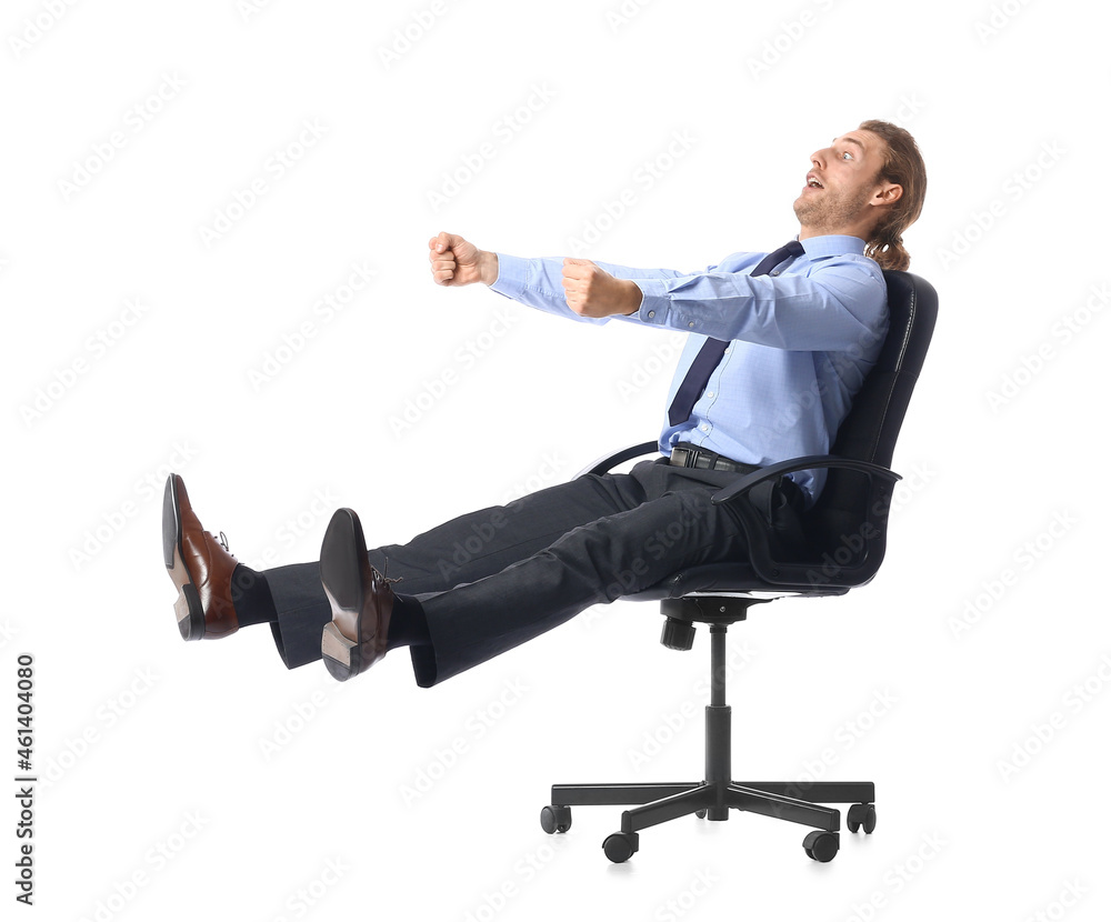 Young man with imaginary steering wheel sitting on chair against white background