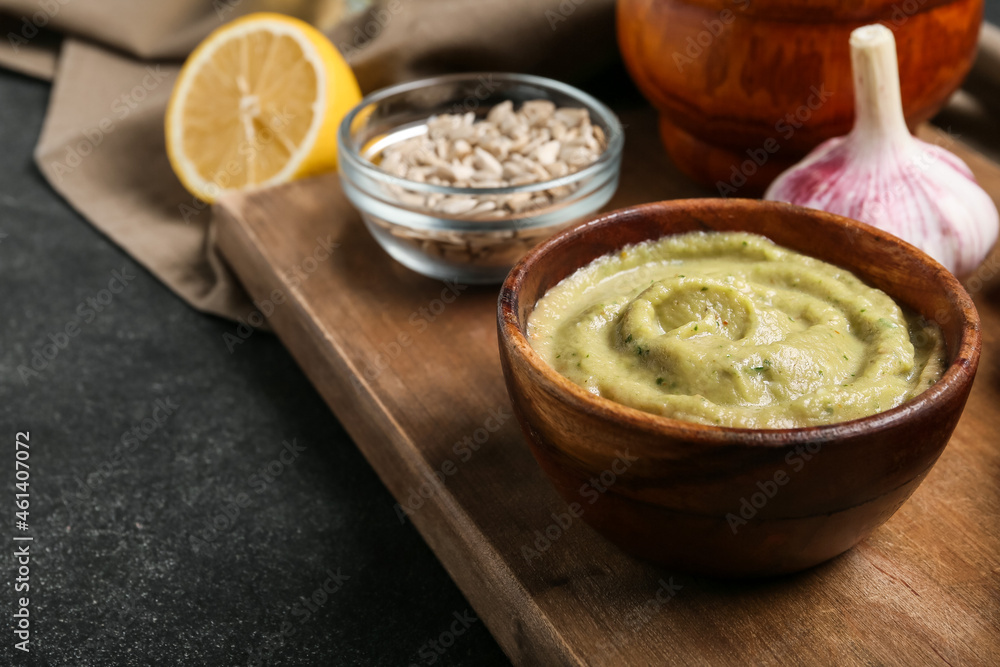 Bowl with tasty baba ghanoush on dark background, closeup