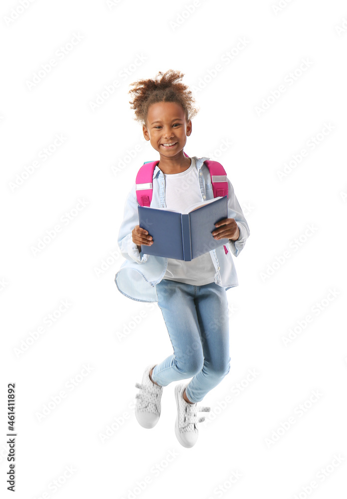 Jumping African-American schoolgirl with book on white background