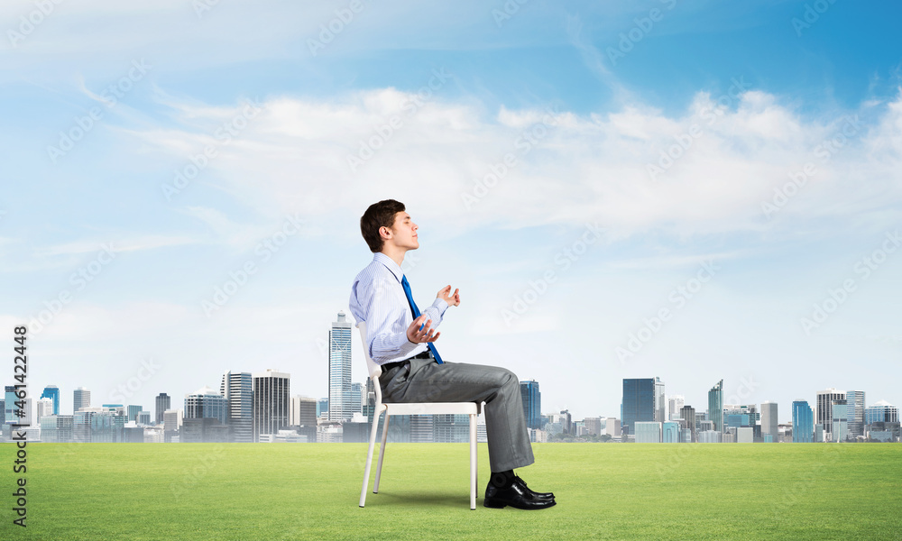 businessman meditates on office chair