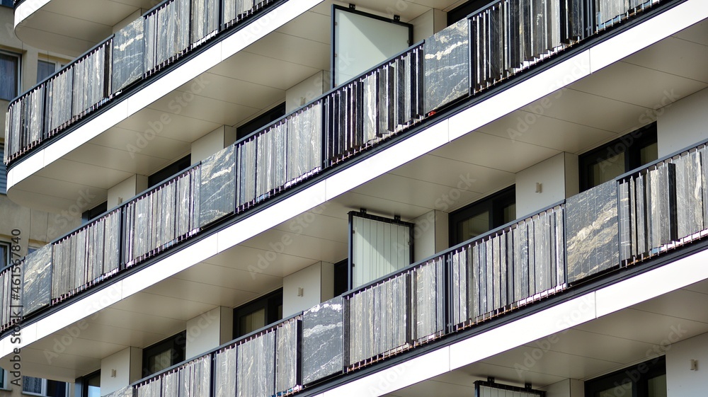 Modern apartment building. Modern urban architecture and details of building facade. Sunlight.