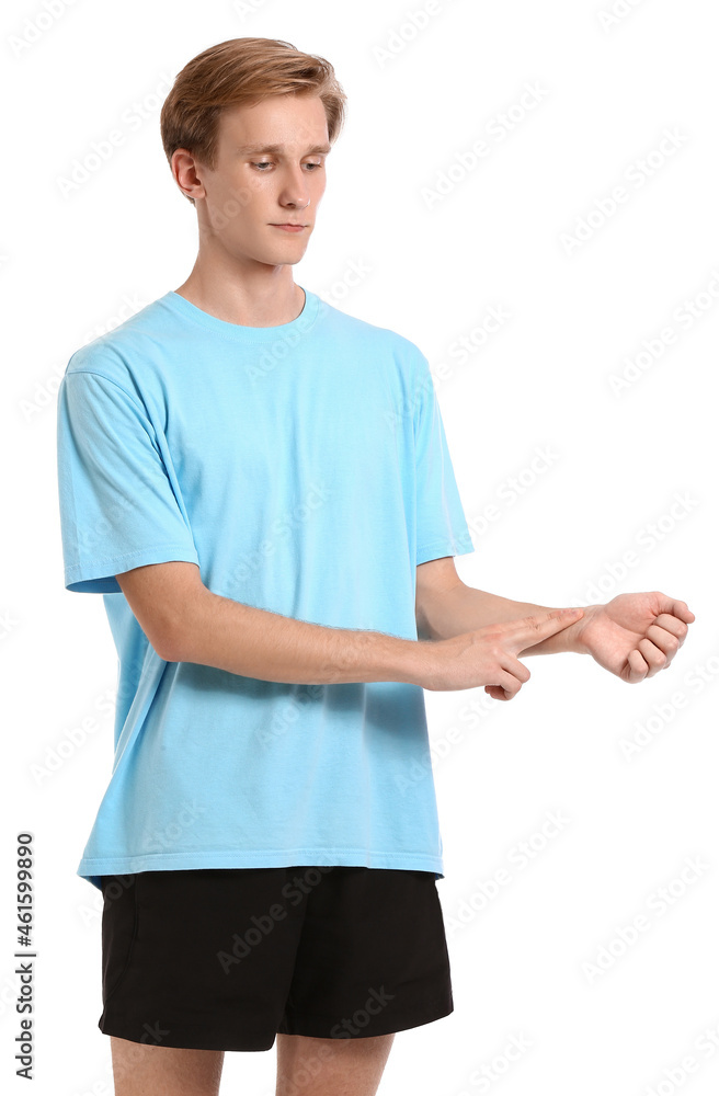 Sporty young man counting pulse on white background