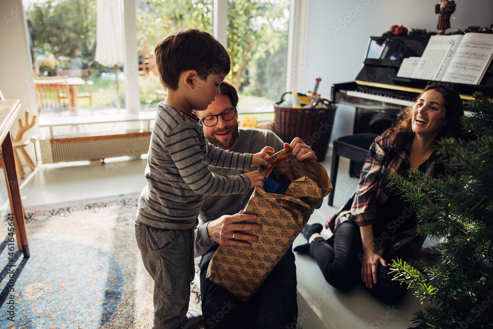 Family opening Christmas gifts together