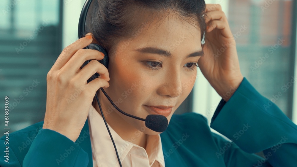 Businesswoman wearing headset working actively in office . Call center, telemarketing, customer supp