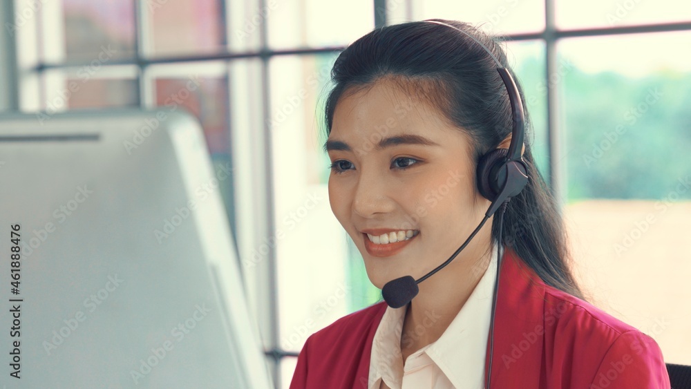 Businesswoman wearing headset working actively in office . Call center, telemarketing, customer supp