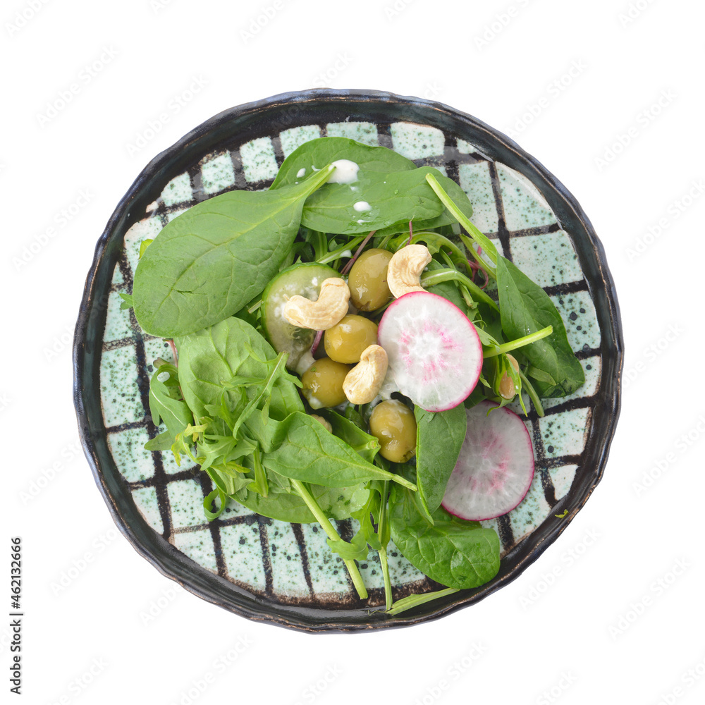 Plate with healthy salad and cashew nuts on white background