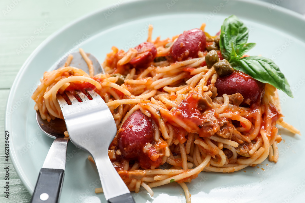 Plate of tasty Pasta Puttanesca on white wooden background, closeup