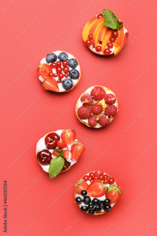 Tasty berry tartlets on color background